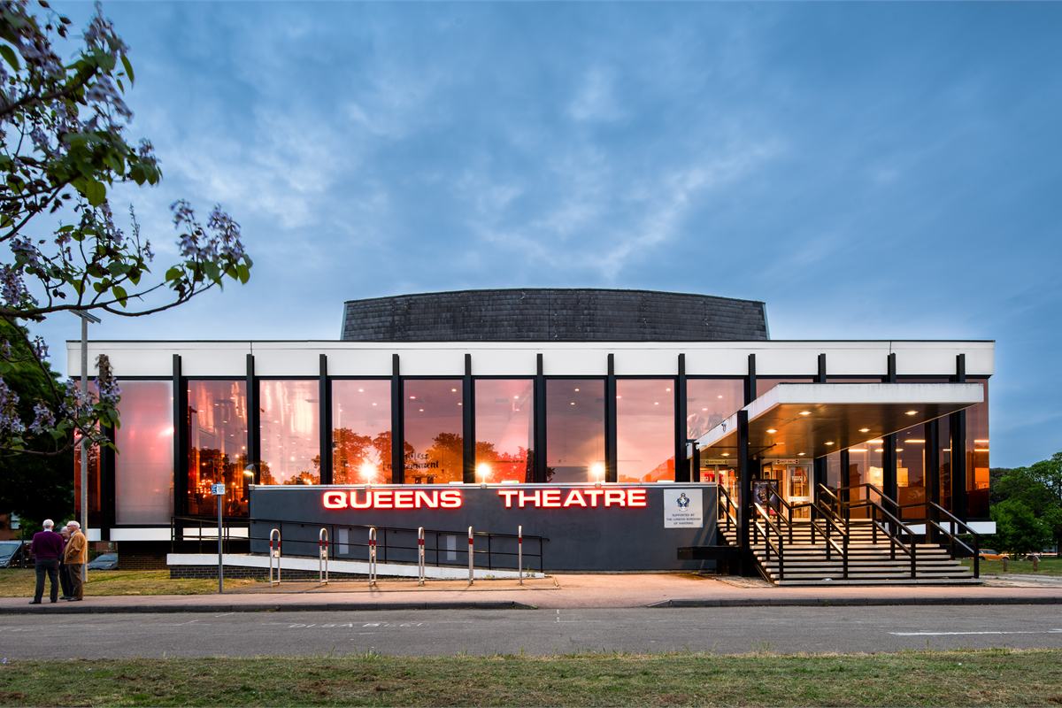 Queen's Theatre Hornchurch lit up at dusk