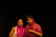The couple wrapped together in red and pink fabric. Photo by Deven Ahire