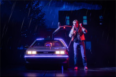 Axel Duffy as Marty McFly beside the DeLorean in the rain. Photo by Mark Senior