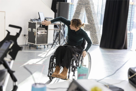 A performer in a wheelchair reaches out across a rehearsal studio during work on Jamie Hale and CRIPtic Arts' Romeo and Juliet. Photo by Shona Louise