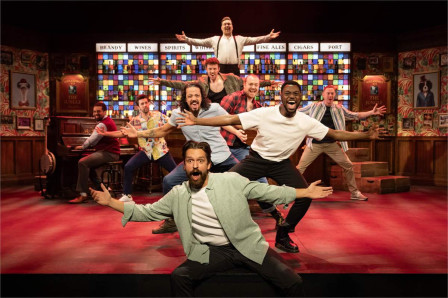 The 2026 touring company of The Choir of Man on the show's pub set. Photo by Mark Senior