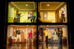 The company of The Comedy About Spies on the four-room hotel set at the Adelphi Theatre