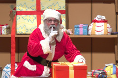 Santa keeps a secret beside a wrapped present in Dear Santa. Photo by Norwell Lapley Productions