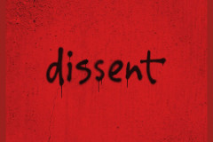 Artwork for dissent by debbie tucker green, the title sprayed in black on a red wall, at the Young Vic