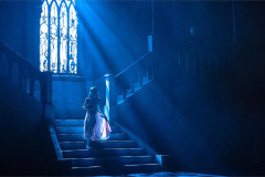 A lone figure on a moonlit castle staircase in BIG Live's Dracula