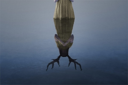 Campaign artwork for English National Opera’s Iphigénie en Tauride: a figure standing in still water above an antlered reflection