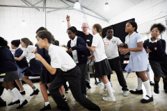 Robert Hayward with the Children's Chorus in rehearsal for ENO's Tosca. Photo by Zoe Martin