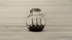Key art for Dogstar at Hampstead Theatre: a sailing ship in a bottle