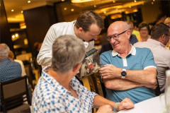 Manuel leans in to a table of diners at Faulty Towers The Dining Experience. Photo by That’s Up