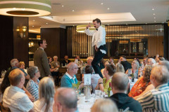 Manuel clambers above a packed dining room at Faulty Towers The Dining Experience. Photo by That’s Up