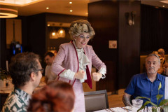 Sybil holds court at a table at Faulty Towers The Dining Experience. Photo by That’s Up