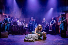 Brenock O'Connor as Woyzeck kneels beside Marie in front of the company in Franz & Marie at Charing Cross Theatre. Photo by Danny Kaan