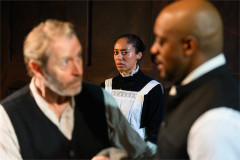 Peter F. Gardiner as Jacob Engstrand, Cecilia Appiah as Regina Engstrand and Oliver Alvin-Wilson as Pastor Manders in Ghosts at Jermyn Street Theatre. Photo by David Monteith-Hodge