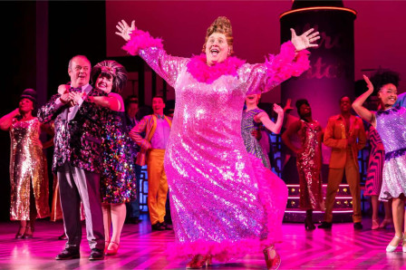 Edna Turnblad and the company in a previous UK tour of Hairspray. Photo by Pamela Raith