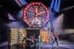 The company of Kimberly Akimbo on Soutra Gilmour's neon clock set at Hampstead Theatre. Photo by Marc Brenner