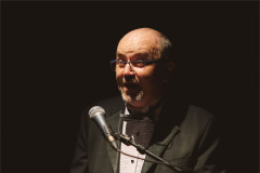 James Heather sings into a microphone in a dinner jacket and bow tie. Photo by Luke Waddington