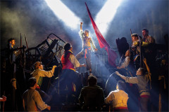 The company of Les Misérables at the barricade in Cameron Mackintosh’s West End production at the Sondheim Theatre. Photo by Danny Kaan