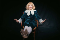 Jordana Belaiche as Little Lord Fondleroy, seated with feet up and arms spread wide