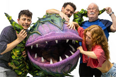 Jed Berry, Benjamin Yates, Maisie Smith and Michael Starke wrestling with Audrey II in rehearsals for Little Shop of Horrors. Photo by Rosie Moore / The Social Sort