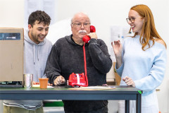 Jed Berry, Michael Starke and Jessie Elland around the flower shop counter in rehearsals for Little Shop of Horrors. Photo by Rosie Moore / The Social Sort