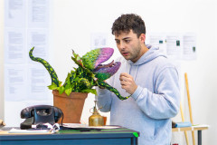 The Audrey II puppet opening wide on Jed Berry as Seymour in rehearsals for Little Shop of Horrors. Photo by Rosie Moore / The Social Sort