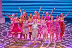 Ellie Gilbert-Grey (centre) as Sophie with the cast of Mamma Mia! at the Novello Theatre. Photo by Brinkhoff & Mögenburg