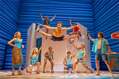 Charlie Garton (centre) as Pepper with the cast of Mamma Mia! at the Novello Theatre. Photo by Brinkhoff & Mögenburg