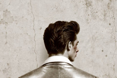Artwork for Mojo at Park Theatre: a young man with a quiff and a metallic jacket, seen from behind against a cracked wall