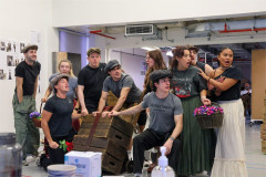 The My Fair Lady ensemble in rehearsal with flower baskets and crates. Photo by Chris Keatch