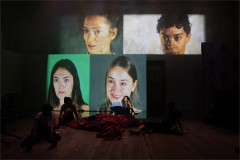 The four Ninas, Maya Bartley O'Dea, Samantha Begeman, Nina Bowers and Gemma Barnett, on screen in NINA at Battersea Arts Centre. Photo by Ali Wright