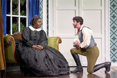 Vinnie Heaven as Mary's Teacher kneels before Lolly Adefope as Mary Todd Lincoln in Oh, Mary! at the Trafalgar Theatre. Photo by Manuel Harlan