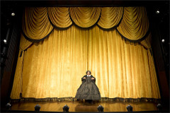 Lolly Adefope as Mary Todd Lincoln alone before the gold curtain in Oh, Mary! at the Trafalgar Theatre. Photo by Manuel Harlan