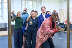 Giles Terera as Ebenezer Scrooge with members of the company in rehearsal for A Christmas Carol at the Old Vic. Photo by Manuel Harlan