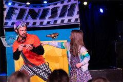 A young audience member helps Baffo with a set of handlebars in On Your Bike Baffo! Photo by Paul Blakemore