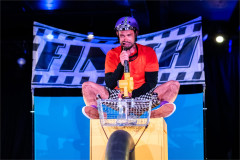 Baffo sings from a shopping basket in On Your Bike Baffo! Photo by Paul Blakemore