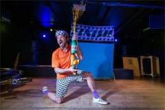 Baffo kneels with his decorated pump in On Your Bike Baffo! Photo by Paul Blakemore