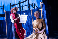 Antonia Layiwola and Adeola Yemitan, with a hand-written alphabet chart, in Once Upon a Time in Sokoto. Photo by Tristram Kenton