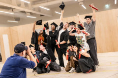 The One Day company in graduation gowns and mortarboards during rehearsals. Photo by Pamela Raith