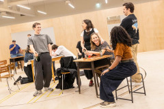 The One Day company working on a scene around a table. Photo by Pamela Raith