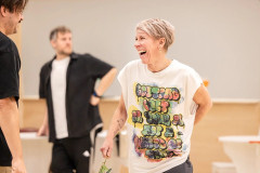 A One Day cast member laughing during rehearsals. Photo by Pamela Raith