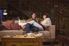Ty Fanning as James and Ami Okumura Jones as Lou on the sofa in Paranormal Activity. Photo by Matt Crockett