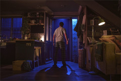 Ty Fanning as James facing an open doorway, bat in hand, in Paranormal Activity. Photo by Matt Crockett