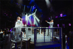 Peter Andre and a fellow performer singing on the raised stage in Mamma Mia! The Party at The O2. Photo by Grant Walker