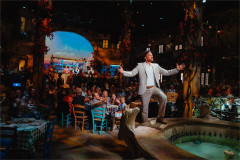 Peter Andre as Nikos greeting guests in the taverna at Mamma Mia! The Party, The O2. Photo by Grant Walker