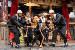 Puppeteers steer the wooden Pinocchio puppet in the 2025 production at Shakespeare’s Globe. Photo by Johan Persson