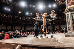 Pinocchio and his puppeteers in front of a full Globe audience, 2025 production. Photo by Johan Persson
