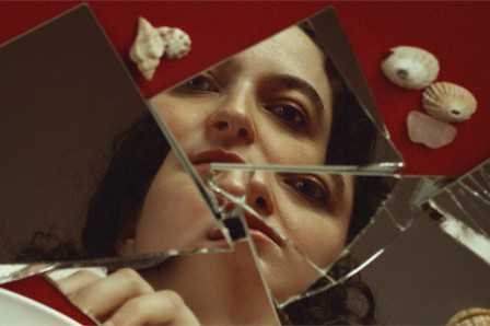 Campaign image for Sharp Edges at Camden People’s Theatre: a face reflected in the shards of a broken mirror