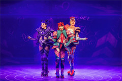 Three coaches perform in purple light in Starlight Express at the Troubadour Wembley Park Theatre. Photo by Pamela Raith