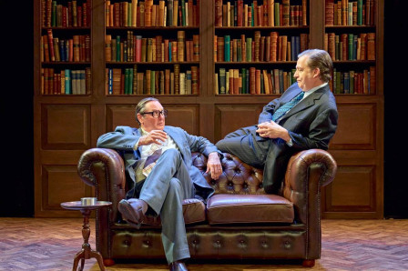 Two of the Gang of Three on a leather Chesterfield sofa in front of the bookshelves at Richmond Theatre