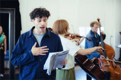 A performer sings from the score in rehearsals for The Pianist. Photo by Rich Southgate